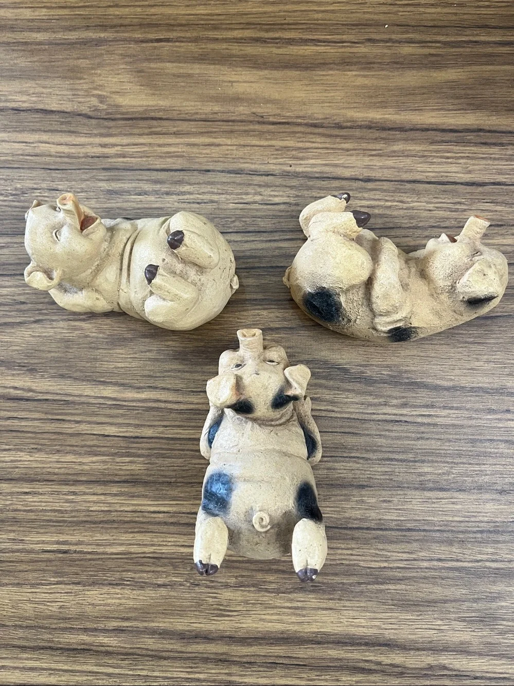 Set of three frolicking pigs